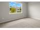 Bright bedroom with carpeted floor and a large window at 11217 Livewell Ct, Venice, FL 34293