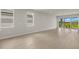 Spacious living room with light gray walls and wood-look floors at 11217 Livewell Ct, Venice, FL 34293