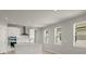 Open living room and kitchen with light gray walls and wood-look floors at 11217 Livewell Ct, Venice, FL 34293
