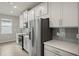 Modern kitchen with stainless steel appliances and white cabinets at 11223 Livewell Ct, Venice, FL 34293