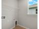 Laundry room with wire shelving and a built-in pet door at 11223 Livewell Ct, Venice, FL 34293