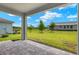 Covered patio overlooking a large backyard at 11223 Livewell Ct, Venice, FL 34293