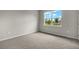 Bright bedroom with carpet flooring and a large window at 11223 Livewell Ct, Venice, FL 34293