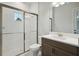 Modern bathroom with a walk-in shower, toilet and vanity with a quartz countertop at 6225 Hidden Branch Dr, Apollo Beach, FL 33572