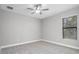 Cozy bedroom with carpet flooring and a window at 17059 Nokota Ave, Hudson, FL 34667