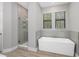 Modern bathroom with a soaking tub and walk-in shower at 17059 Nokota Ave, Hudson, FL 34667