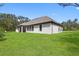 Large backyard with covered patio and outdoor kitchen at 17059 Nokota Ave, Hudson, FL 34667