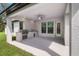 Covered patio with outdoor kitchen and ceiling fan at 17059 Nokota Ave, Hudson, FL 34667