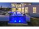 Luxurious home featuring an infinity pool with water feature and elegant outdoor lighting at 5032 W Longfellow Ave, Tampa, FL 33629