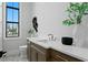 Stylish powder room with modern vanity, elegant fixtures, and natural light creates an inviting space at 5032 W Longfellow Ave, Tampa, FL 33629