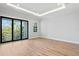 Bright bedroom with sliding glass doors, neutral paint, and hardwood flooring at 5032 W Longfellow Ave, Tampa, FL 33629