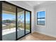 Bright bedroom featuring hardwood floors, a window, and access to a private balcony at 5032 W Longfellow Ave, Tampa, FL 33629