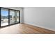 This bedroom has wood floors and a large sliding glass door at 5032 W Longfellow Ave, Tampa, FL 33629
