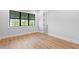 Minimal bedroom with light wood floors and large window at 5032 W Longfellow Ave, Tampa, FL 33629