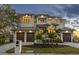 This home features a three-car garage and luscious landscaping at 5032 W Longfellow Ave, Tampa, FL 33629