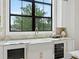 Bright kitchen with a farmhouse sink, wine cooler, marble countertops, and natural light at 5032 W Longfellow Ave, Tampa, FL 33629