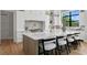 Well-lit kitchen with marble countertops, chevron backsplash, and stainless steel appliances adds modern flair at 5032 W Longfellow Ave, Tampa, FL 33629
