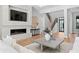 Cozy living room featuring a fireplace, a staircase, and hardwood floors at 5032 W Longfellow Ave, Tampa, FL 33629