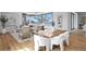 Bright living room with hardwood floors, a modern fireplace, neutral furniture, and scenic outdoor views at 5032 W Longfellow Ave, Tampa, FL 33629