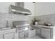 Outdoor kitchen featuring stainless steel appliances and a built-in grill at 5032 W Longfellow Ave, Tampa, FL 33629
