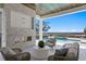 Inviting outdoor living area with a fireplace and water view at 5032 W Longfellow Ave, Tampa, FL 33629