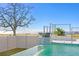 Picturesque pool featuring a waterfall feature with bay views and a majestic oak tree backdrop at 5032 W Longfellow Ave, Tampa, FL 33629