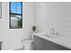 This powder room has shiplap walls and marble counters at 5032 W Longfellow Ave, Tampa, FL 33629
