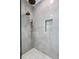Modern shower with marble-like tile, bronze fixtures, and convenient built-in niche at 5032 W Longfellow Ave, Tampa, FL 33629