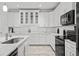 Modern kitchen with white cabinets, marble countertops and stainless steel appliances at 6409 Oyster Island Cv, Apollo Beach, FL 33572