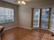 Bright living room with laminate flooring and bay windows at 201 Silver Lake Dr # 101, Venice, FL 34292