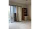 Living room with sliding glass door and bookcase at 201 Silver Lake Dr # 101, Venice, FL 34292