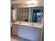 Bathroom with double vanity and large mirror at 201 Silver Lake Dr # 101, Venice, FL 34292