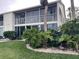 Condo building with balconies and tropical landscaping at 201 Silver Lake Dr # 101, Venice, FL 34292
