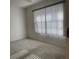 Bright bedroom with large window and neutral walls at 201 Silver Lake Dr # 101, Venice, FL 34292