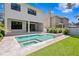 A view of the backyard pool and patio with a modern home design at 3109 W Knights Ave, Tampa, FL 33611