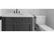 Bathroom vanity with marble countertop, dark gray cabinets, and black hardware at 3109 W Knights Ave, Tampa, FL 33611