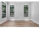Spacious bedroom featuring hardwood floors, neutral walls, and large windows at 3109 W Knights Ave, Tampa, FL 33611
