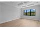 Light-filled bedroom boasts coffered ceilings, hardwood floors, and large windows with a view at 3109 W Knights Ave, Tampa, FL 33611