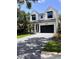 Beautiful two story home with a black garage door and brick driveway at 3109 W Knights Ave, Tampa, FL 33611