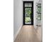 Bright foyer featuring hardwood floors and a black-trimmed front door with glass panels at 3109 W Knights Ave, Tampa, FL 33611