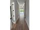 Hallway leading to the backyard with dark brown flooring and views of the back yard at 3109 W Knights Ave, Tampa, FL 33611