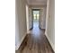 Hallway leading to the primary bedroom with dark brown flooring and baseboards at 3109 W Knights Ave, Tampa, FL 33611