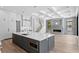 Beautiful open kitchen featuring an island, stainless appliances, coffered ceilings, and fireplace at 3109 W Knights Ave, Tampa, FL 33611