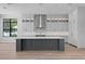 Bright modern kitchen with a large center island, stainless steel appliances and white cabinets at 3109 W Knights Ave, Tampa, FL 33611