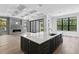 Modern kitchen with white countertops, a gray island, and a cozy fireplace at 3109 W Knights Ave, Tampa, FL 33611