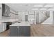 Spacious open kitchen featuring a large island, stainless appliances, and a view of the stairs at 3109 W Knights Ave, Tampa, FL 33611