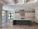 Spacious kitchen featuring a large island, custom cabinetry, and stainless steel appliances at 3109 W Knights Ave, Tampa, FL 33611