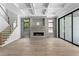 Bright living room featuring a fireplace, coffered ceilings, wood floors and a staircase with glass panels at 3109 W Knights Ave, Tampa, FL 33611