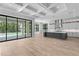 Open-concept living room with a modern kitchen, an island and sliding glass doors to the backyard and pool at 3109 W Knights Ave, Tampa, FL 33611