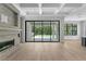 Bright living room with a fireplace, hardwood floors, and sliding glass doors to the patio and pool area at 3109 W Knights Ave, Tampa, FL 33611